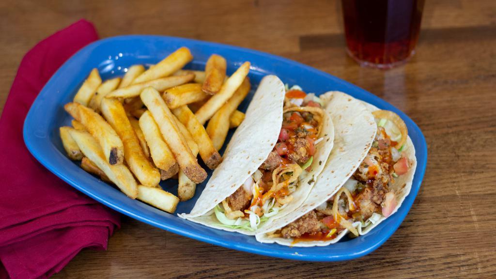 Chicken Tacos · Diced chicken tenders, mango habanero sauce, green cabbage, housemade Pico, and crispy onion straws in two soft flour tortillas.