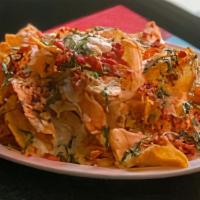 Loaded Potato Nachos · Crispy housemade potato chips, applewood bacon, beer cheese queso served with green chile ja...
