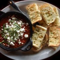 Baked Goat Cheese Marinara · Warm goat cheese, classic red sauce, fresh basil. Served with crispy bread.