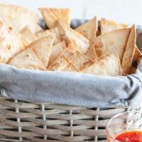 Tortilla Chips · Crispy corn tortilla chips. Flash fried and locally made. Seasoned with salt and sugar. Vega...