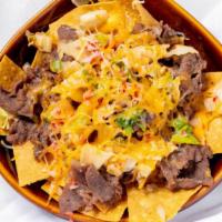 Kimchi Bulgogi Nachos · Ultimate nachos with the full flavor of Korean-marinated beef and pan-fried kimchi topped wi...
