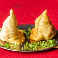 Vegetable Samosas · Two crisp patties filled with potatoes and peas, mildly spiced, and deep fried.