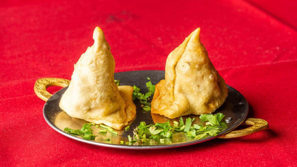 Vegetable Samosas · Two crisp patties filled with potatoes and peas, mildly spiced, and deep fried.