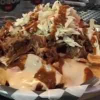 Pig Chips · Pub chips, house-made queso, pulled pork, slaw, jalapeños, ancho bbq.