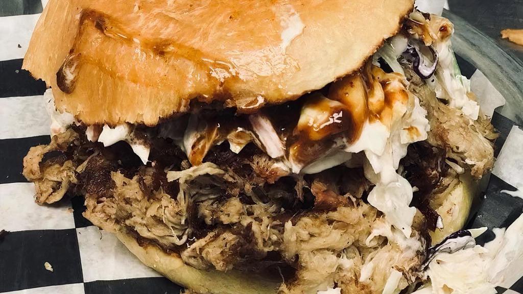 Pork Sandwich · House-smoked pulled pork served with slaw on a brioche bun. Choice of ancho bbq (mustard base) or house bbq. Limited quantity per day!