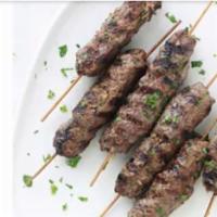 Kefta Plate · Ground lamb and beef skewered and grilled, served over rice with two sides.