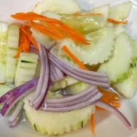 #19 Cucumber Salad. · A small plate of fresh cucumber and red onion with a mild & sour sauce.