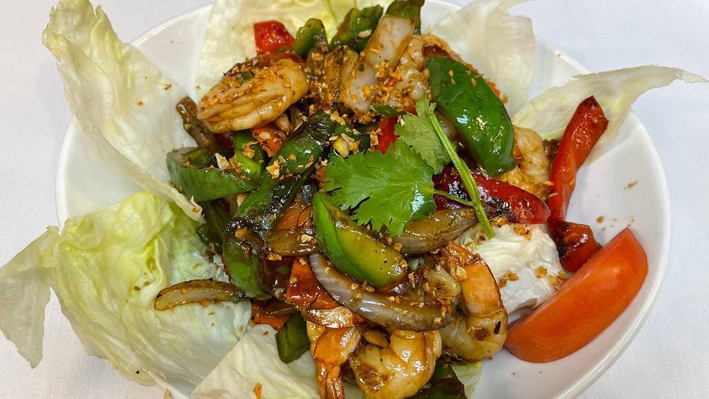 #48 Pad Kratiam. · Marinated chicken, pork, or beef pan-fried with crushed garlic, ground pepper, diced bell pepper, and scallion. Thinly sliced and served on a bed of fresh cucumber and lettuce.