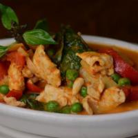 #56 Red Curry. · Savory red curry sauce, coconut milk, green pea, bamboo shoot, bell pepper, and basil leaves.