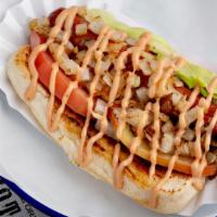 California Baby Dog · Beef hot dog topped with lettuce, tomato, grilled onions, guacamole, and try me sauce.
