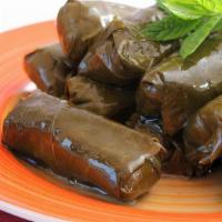 Dolma · Six pieces of grape leaves stuffed with season in rice and special herbs.
