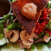Sweet Blackened Tuna Salad · Tropically blackened Ahi Tuna topped with our Mango-Pineapple Chutney, served over our Cabo ...