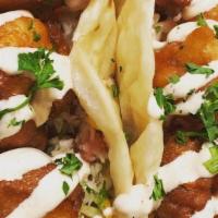 Beer Battered Shrimp Tacos · Beer battered shrimp topped with our Cilantro White Sauce, stuffed with cabbage, tomato & gu...