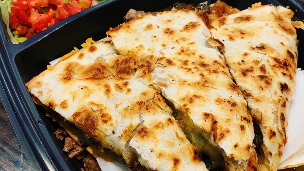 Steak Quesadilla · A grilled flour tortilla stuffed with sautéed peppers & onions, mixed cheese & grilled steak