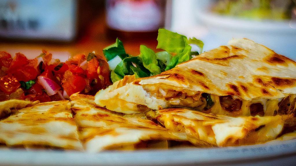Chicken Quesadilla · A grilled flour tortilla stuffed with sautéed peppers & onions, mixed cheese & grilled chicken