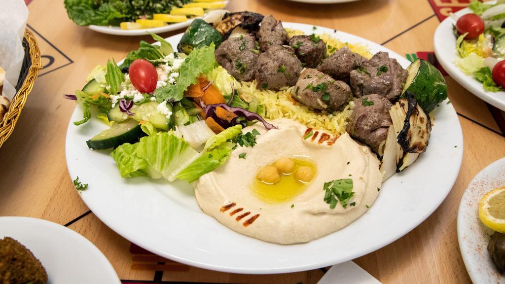 Lamb Kabob (Plate) · Savory lamb filet cuts grilled to perfection. Plate includes rice, hummus, salad, and pita.(2 skewers)