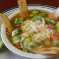 Chicken Tortilla Soup · Crispy fried strips of corn tortilla in a tomato-based Mexican soup with chicken stock, pico...