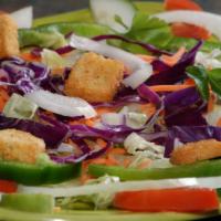 Green Salad · Lettuce with tomatoes, onions, bell peppers, cucumbers, cabbage and croutons topped with whi...