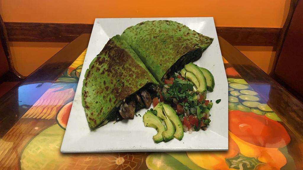 Quesadilla Agricola · 10- inch wheat and spinach tortilla stuffed with cheese, spinach and mushrooms with pico de gallo and sliced avocado.