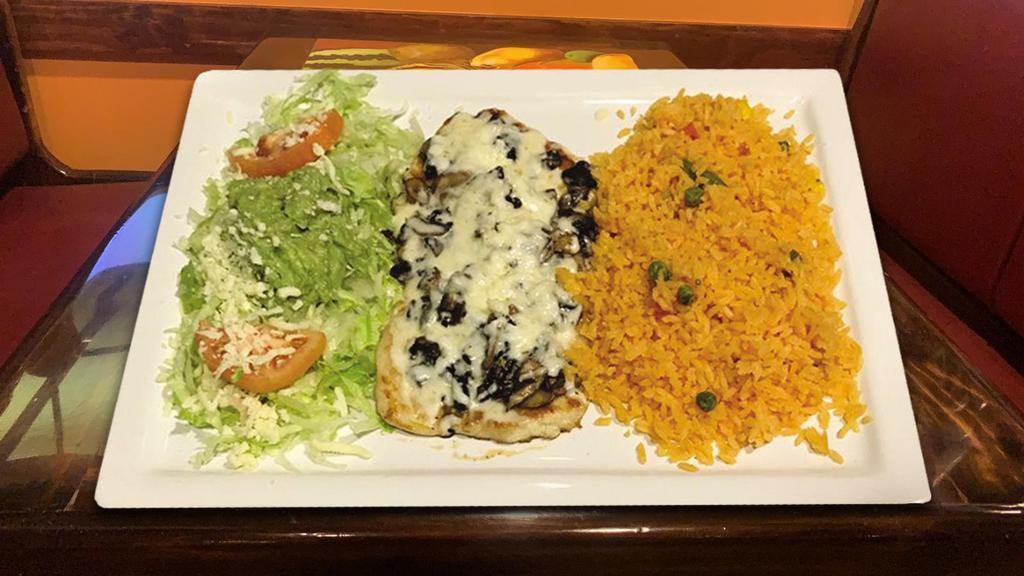 Pollo Jaliciense · Chicken breast topped with cheese and mushrooms. Served with rice, guacamole salad, and tortillas.