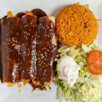 Enchiladas Poblanas · Three enchiladas with chicken topped with poblano sauce. Served with rice and sour cream sal...