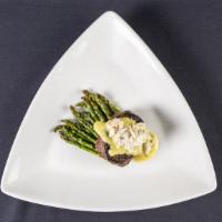 Signature Steak Oscar · Steak tenderloin served with truffle asparagus, jumbo lump crab meat, bearnaise sauce.