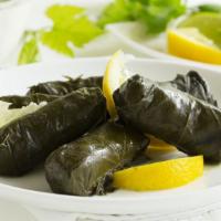 Grape Leaves (Dolmades) · (6.pcs) Rolled grape leaves stuffed with seasoned rice and grilled onions served with one si...