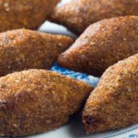 Fried Kibbeh (2.Pcs) · Finley paste of a bulgur and lamp filled with ground beef formed into balls and fried