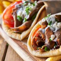 Gyro Wrap · grilled  gyro meat lamb-beef with fresh cuts of tomatoes, red onions, lettuce, and tzatziki ...