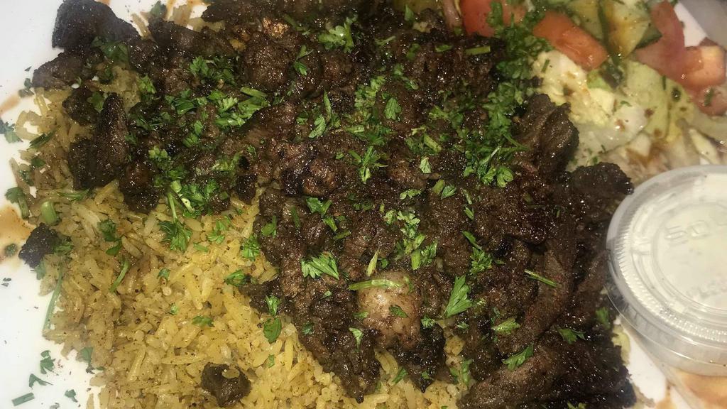 Lamb & Beef Shawarma Plate · served on bed w rice side salad pita bread and taziki