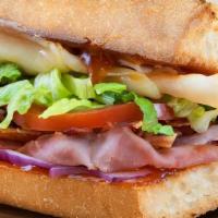 Honey Bacon Club Sandwich · Turkey, ham, Swiss cheese, lettuce, tomatoes, onions, and honey-French dressing with italian...