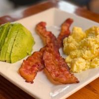 Jon'S Breakfast · Scrambled eggs served with two slices of crispy bacon and half of an avocado.