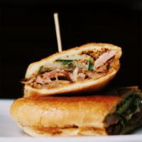 Cuban Sandwich · All natural hormone free and free range babe. Ham, pulled pork, pickles, stout mustard, cara...
