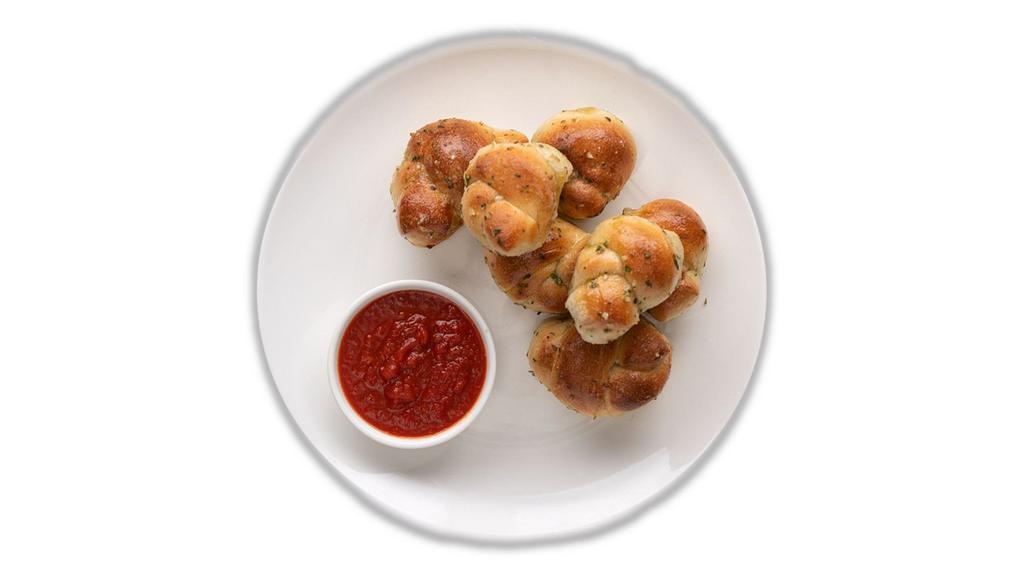 Garlic Knots (8) · Freshly Baked with savory blend of Fresh Garlic, Virgin Olive Oil, Oregano & Parsley finished with Parmesan.