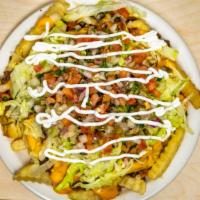Asada Fries · Fries loaded with your choice of meat, nacho cheese, pico de gallo, lettuce, and sour cream.