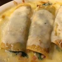Spinach Enchiladas · Vegetarian. Three rolled tortillas filled with spinach and topped with cheese.