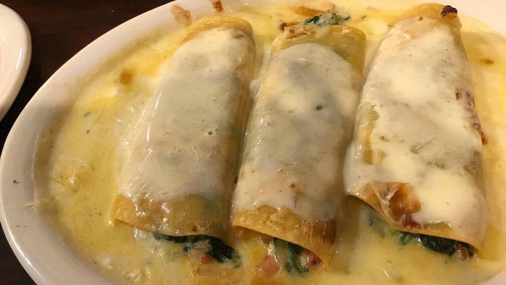 Spinach Enchiladas · Vegetarian. Three rolled tortillas filled with spinach and topped with cheese.