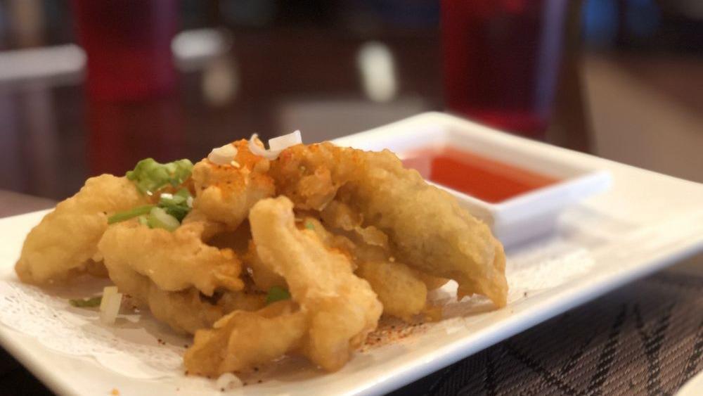 Fried Calamari · Deep-fried crispy calamari on topped with cilantro, seasoning salt, green onion served with a spicy-sweet sauce.