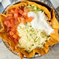 Taco Salad · Shredded chicken, ground beef
or refried beans topped with
lettuce, sour cream, guacamole,
c...