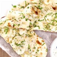 Garlic Naan · Naan bread topped with pressed garlic & fresh herbs.