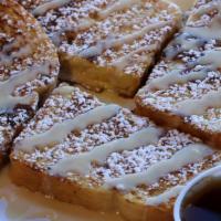 Cinnamon Roll French Toast · Four pieces of French Toast drizzled with our cream cheese sauce topped with powdered sugar ...