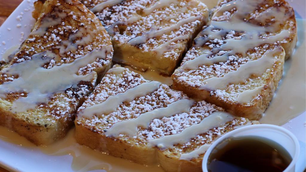 Cinnamon Roll French Toast · Four pieces of French Toast drizzled with our cream cheese sauce topped with powdered sugar and served with side of syrup.
