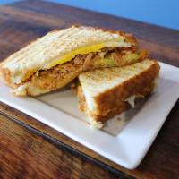 Hot Chicken Sandwich · Hot chicken, avocado and mozzarella topped with a fried egg on sourdough bread and served wi...