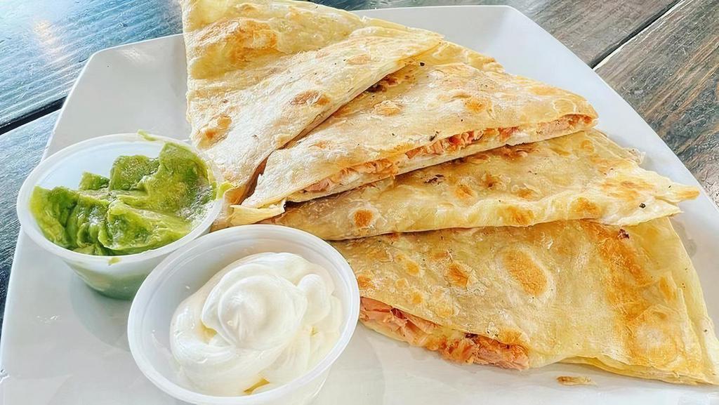 Hot Chicken Quesadilla · Shredded chicken tossed in hot chicken seasoning and melted with a Mexican cheese blend. Served on a flour tortilla with a side of guacamole and sour cream.