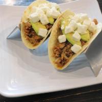 Honey Balsamic Tacos · Chicken and caramelized onion cooked in a honey balsamic glaze topped with feta and avocado.