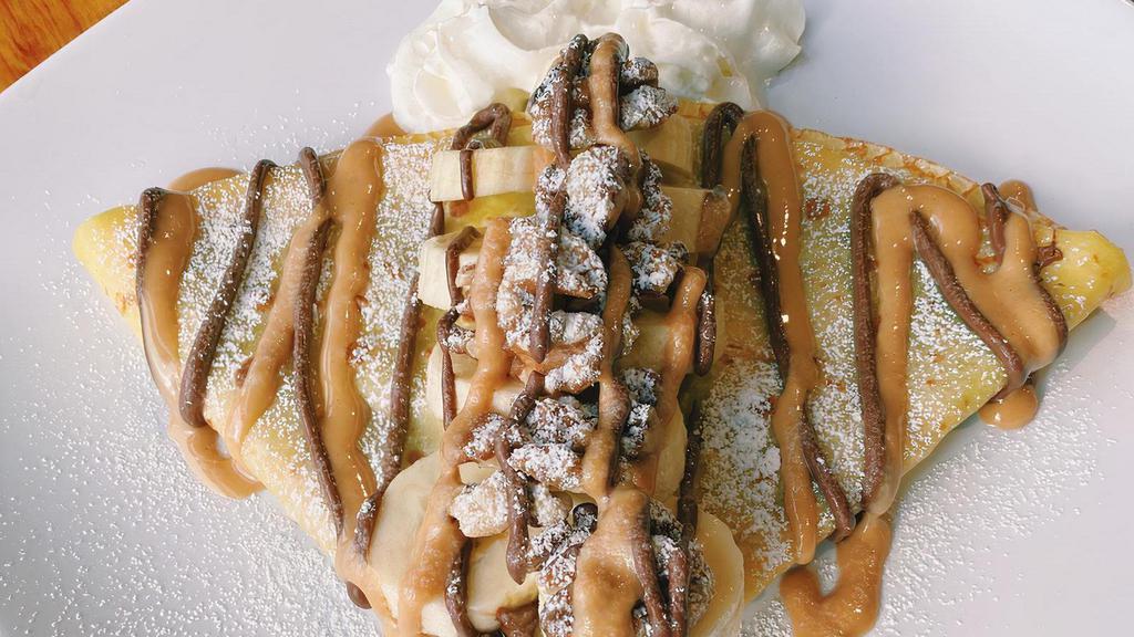 Funky Monkey Mini · A half-size version of our best-selling Funky Monkey crepe! Enjoy the perfect portion of this Nutella, peanut butter, walnut and banana bliss topped with whipped cream and powdered sugar.