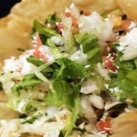 Taco Salad · Your choice of shredded chicken or ground beef in a grande taco shell, with beans, cheese, l...