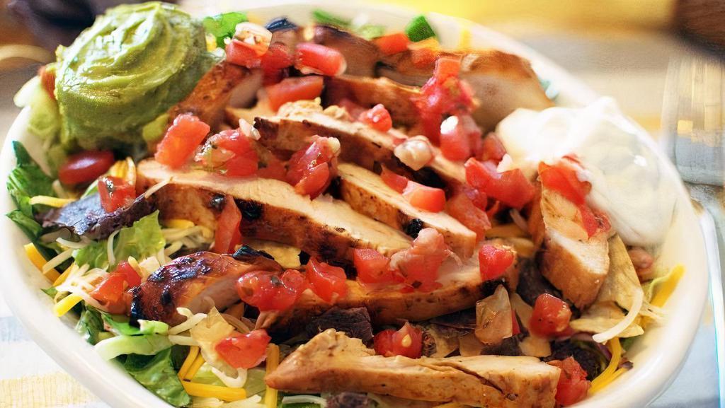 Santa Fe Fajita Salad · Mesquite grilled chicken, steak or shrimp cooked with onions. Tomatoes & green peppers. Served in a grande taco shell, with beans, cheese, lettuce, sour cream, pico de gallo and guacamole.