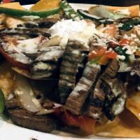 Fajita Nachos · Tortilla chips topped with mesquite grilled chicken or fajita steak. Grilled vegetables and ...