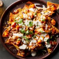 Salsa'S Nachos · Nachos with cheese, ground beef, shredded chicken and beans all topped with lettuce, sour cr...